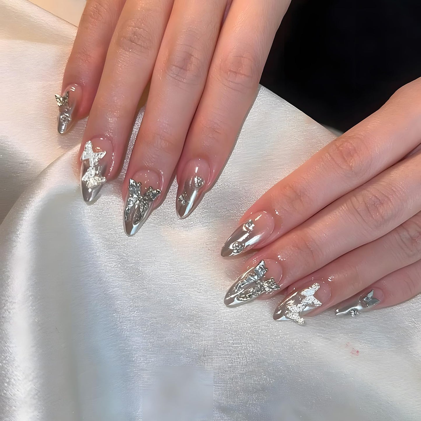 IMSOHOT Medium Almond Press on Nails Silver Chrome Gradient Fake Nails with Metal Butterfly Designs Glossy Full Cover Nude Acrylic Stick on Nails for Women Girls 24Pcs