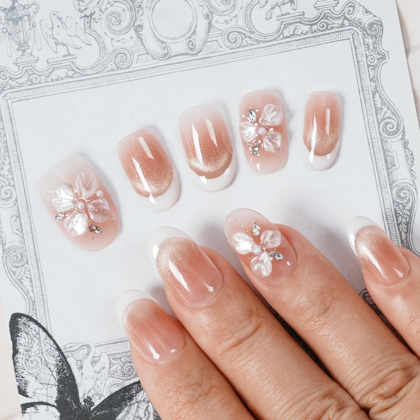 Tesytto Short Oval Press On Nails, Nude Cat Eye Gradient False Nails with White French Tip & 3D Sheer Flower, Reusable Glossy Fake Nails (Gold Shimmer Crystal,M)