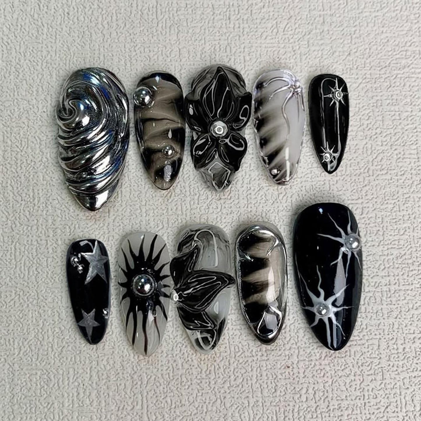 Y2K Gothic Press on Nails, Medium Almond 3D Black Silver Swirl Fake Nails with Embossed Flower & Star Designs, Metallic False Nails with Glue Tabs - 24Pcs Nail Kit for Women French Manicure